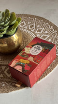 Silk Route Dew of Dunhuang Serum bottle styled in warm natural light on a table