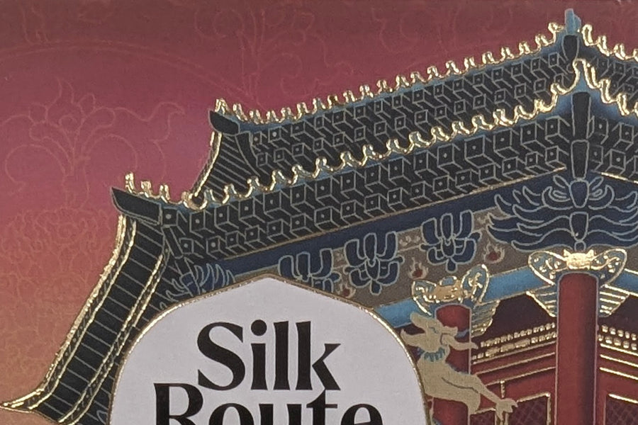 Close-up of the Dew of Dunhuang box: a gold-edged palace roofline above the Silk Route label