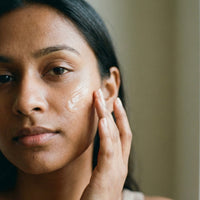 The serum pressed into damp, cleansed skin in warm morning light