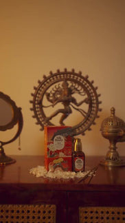 Apothecary bottles and botanicals arranged on a wooden shelf